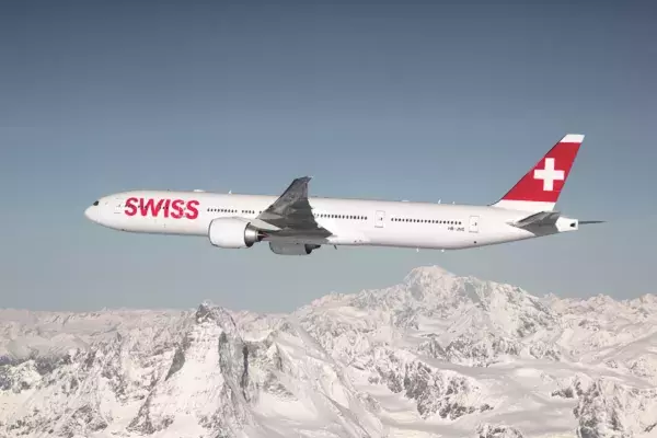 SWISS aircraft flying over mountains