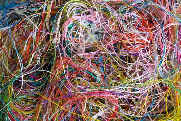 A tangled collection of multicoloured threads