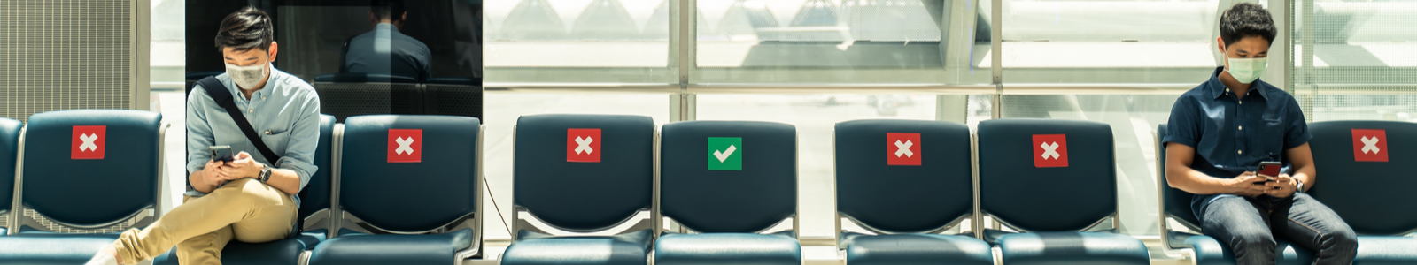 Men socially distanced in an airport