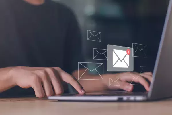 man reading emails on laptop