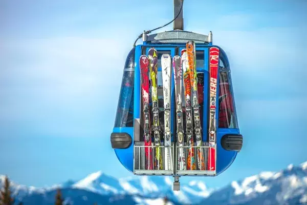 Ski lift with lots of skis lined up