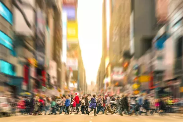 crowds walking through Time Square, New York