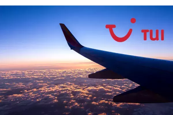 A view of a plane wing from the passenger's seat. Overlaid with a TUI UK logo