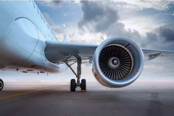 plane on runway, with focus on one engine