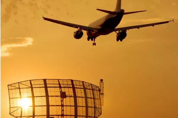 Front cover of eGuide - plane flying over communications satellite dish