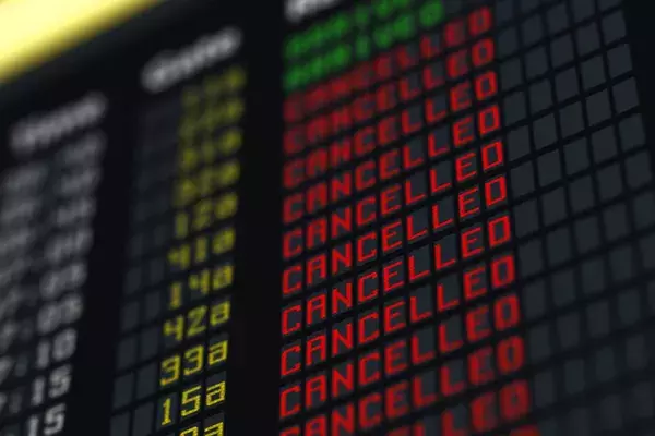 A board in an airport showing all flights as cancelled