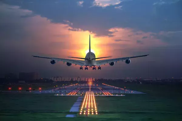 Aircraft taking off into the sunset