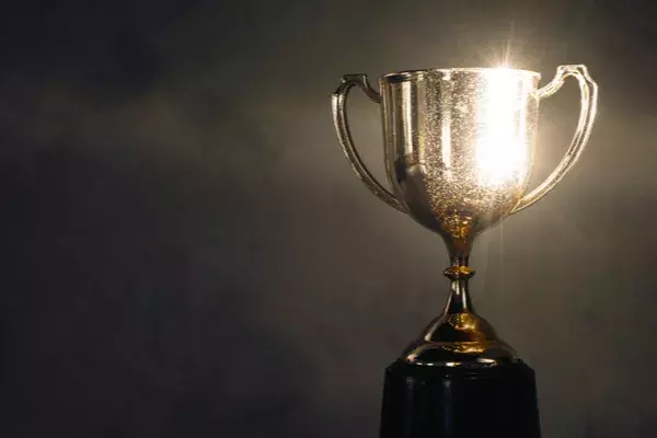 Shiny trophy on dark background