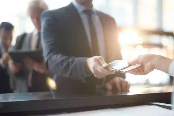 Man taking back his passport and ticket after check-in