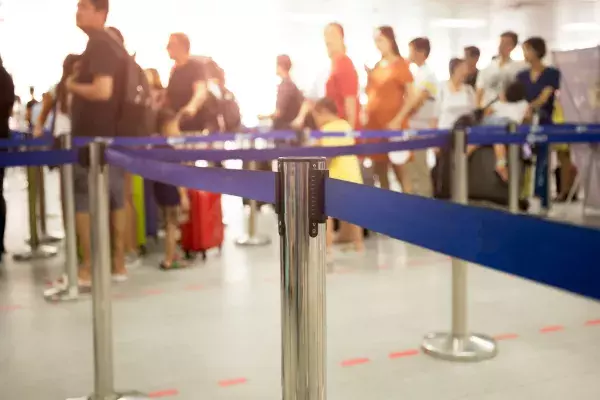 People queuing at an airport during IROPS