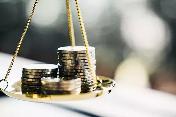 Coins balanced on a scale